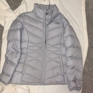 Silver North Face Jacket. Never worn. Size medium. Recently bought.